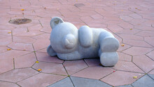 Concrete Decor Of A Sleeping Bear On The Pavement