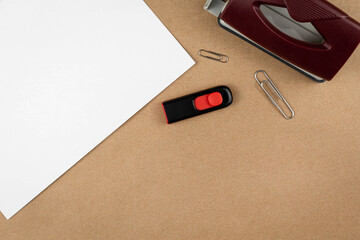 Poster - Work place top view with office supplies on textured recycled craft brown paper backdrop copy space
