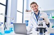 © Krakenimages.com - Young man scientist using laptop and microscope at laboratory