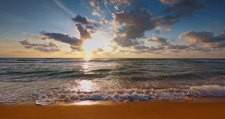 Wall Mural - Sea sunrise with scenic cloudscape over ocean waves and tropical beach, waves on slow motion 4k video