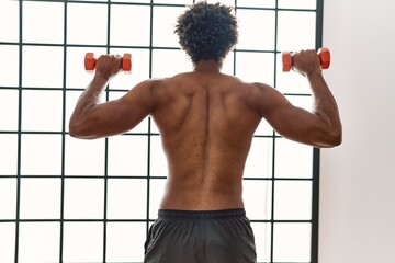 Poster - Young african american man training using dumbbells at beauty center