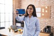 © Krakenimages.com - Young hispanic girl business worker make selfie by smartphone at office
