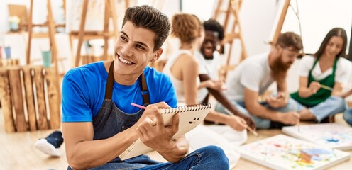 Poster - Group of people smiling happy drawing sitting on the floor at art studio.