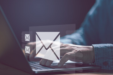 Leinwandbilder - Businessman hands using Laptop typing on keyboard and surfing the internet on office table with email icon, email marketing concept, send e-mail or news letter, online working internet network..
