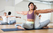 © JackF - Portrait of young adult woman practicing partner yoga at studio