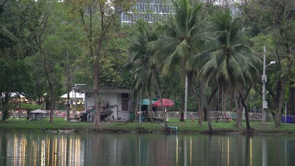 Wall Mural - Lumphini Park In The Morning With Trees Reflections On Lake