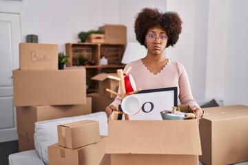 Wall Mural - Young african american woman moving to a new home depressed and worry for distress, crying angry and afraid. sad expression.