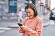 © Krakenimages.com - Middle age woman smiling confident using smartphone at street