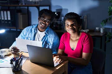 Canvas Print - African american man and woman business workers using laptop working at office