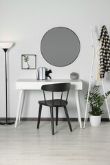 Wall Mural - Stylish room interior with round mirror on white wall over desk