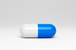 © Cavan Images - Blue and white capsule on white background. 3d render