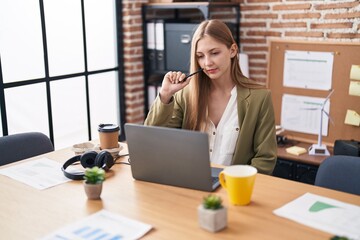 Wall Mural - Young caucasian woman business worker using laptop with serious expression at office