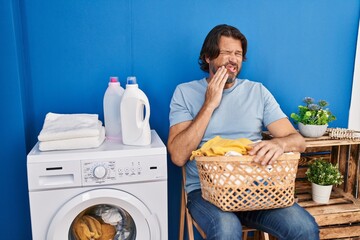 Wall Mural - Handsome middle age man waiting for laundry touching mouth with hand with painful expression because of toothache or dental illness on teeth. dentist