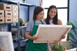 © Krakenimages.com - Two women artists standing together looking draw at art studio