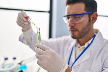 Sticker - Young hispanic man scientist measuring liquid at laboratory