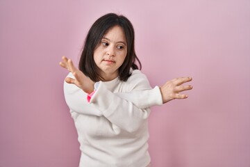 Poster - Woman with down syndrome standing over pink background rejection expression crossing arms doing negative sign, angry face