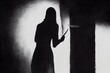 The shadow of a female murderer stood terrifyingly holding a knife and lit from behind.Scary horror or thriller movie mood or nightmare at night Murder or homicide concept.