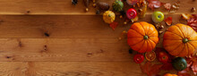 Seasonal Background, With Fall Leaves, Gourds And Berries On A Natural Wood Surface. Thanksgiving Concept With Space For Text.