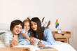 © Pixel-Shot - Lesbian couple with their little daughter taking selfie in bedroom