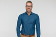 young casual man is wearing a blue shirt and eyeglasses