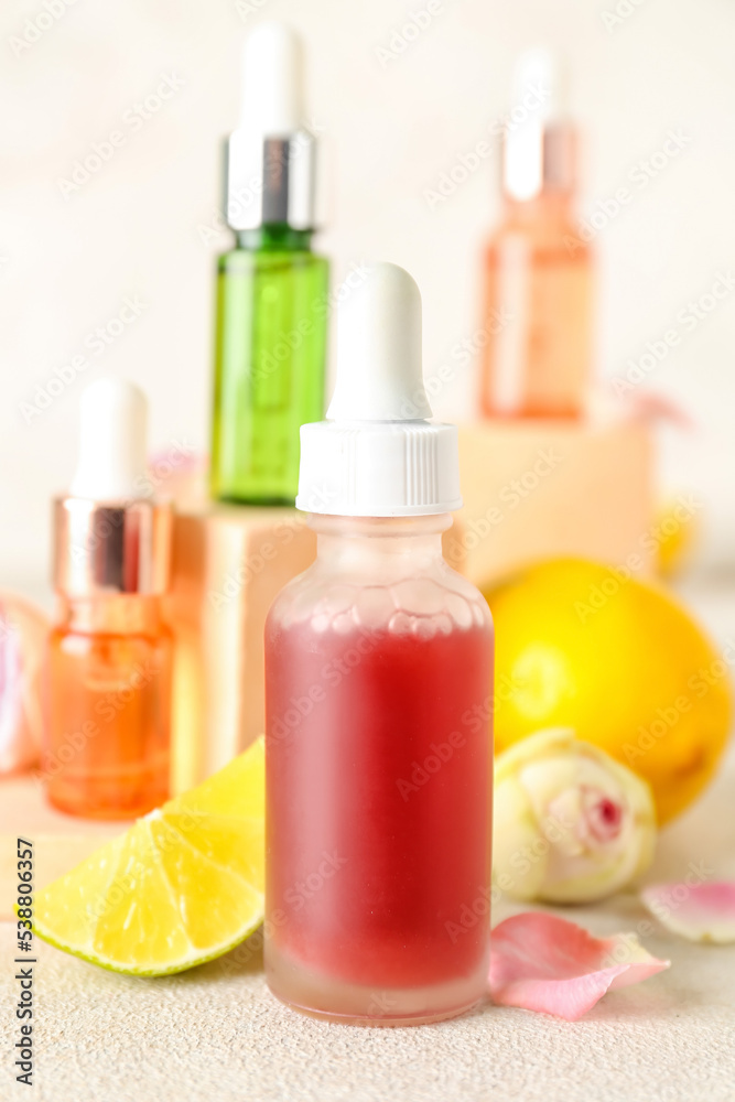 Bottles of citrus serum on light table, closeup