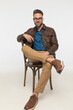 © Viorel Sima - sexy bearded guy with elbow on chair posing with leg on knee