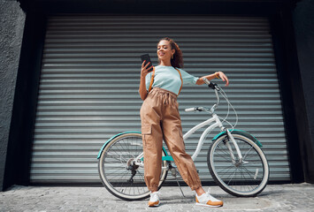 Wall Mural - Bicycle, phone and black woman in city, street or urban road outdoors. Bike, travel and happy female from South Africa on 5g mobile tech, internet browsing or social media, web or online surfing.