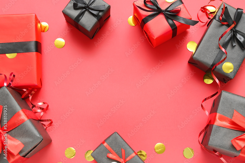 Frame made of gift boxes with confetti on red background. Black Friday sale