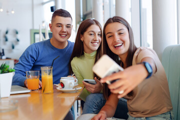 Teenage friends taking selfie with smart phone