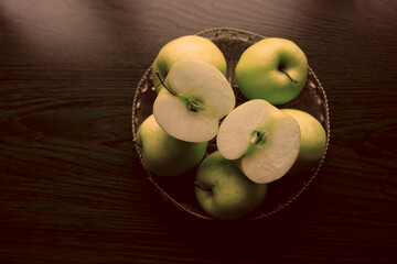 Set of yellow apples on metal plate. Whole fruit without leaf, halves and slice with seeds. A source of vitamins. Food for a healthy diet. Sweet fresh snack.