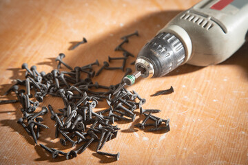 Wall Mural - Drill with screws on the table.