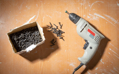 Poster - Drill with screws on the table.