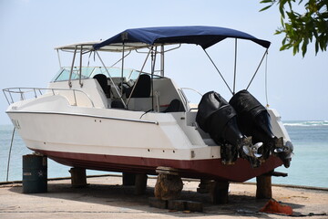 Motor boat with two pair of propellers is on tyres