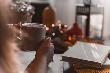 Wall Mural - autumn photo on table with candles drinking coffee