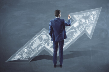 Poster - Back view of businessman with upward business arrow sketch drawing on chalkboard wall background. Success, finance and productivity concept.