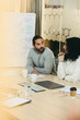 © Jacob Lund - Two young businesspeople attending a meeting in a boardroom