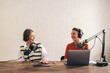 © Jacob Lund - Female content creators recording a podcast in a home studio