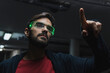 © Westend61 - Man wearing futuristic smart glasses touching augmented interface