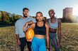 © Westend61 - Multiracial American football players standing together in field