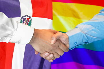 Wall Mural - Business handshake on background of two flags. Men handshake on background of Dominican Republic and LGBT flag. Support concept