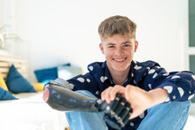 Smiling Boy With Prosthetic Arm Sitting By Furniture