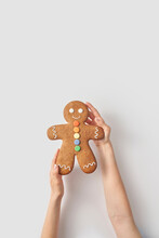 Woman Holding Gingerbread Man Cookie On White Background