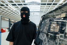 Thief Wearing Mask Standing By Desktop Computer In Industry