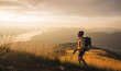 © Westend61 - Man with hiking pole and backpack hiking at sunrise