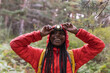 © Westend61 - Happy woman wearing flashlight on forehead standing in forest