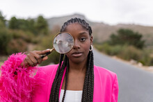 Young Woman With Magnifying Glass On Road