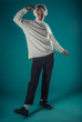 © qunica.com - Male beauty concept. Portrait of fashionable young man with stylish haircut wearing trendy glasses and sweater, posing over gray background. Perfect hair & skin. Hipster style. Copy-space. Studio shot