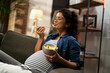 Pregnant woman eating fuit at home. Beautiful pregnant woman enjoy in healthy meal.