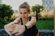 © Halfpoint - Young woman doing stretching in city, preparing for run, healthy lifestyle and sport concept.