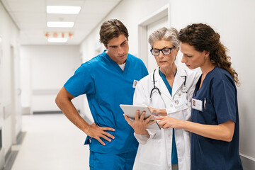 Doctor and nurse discussing patient case at hospital